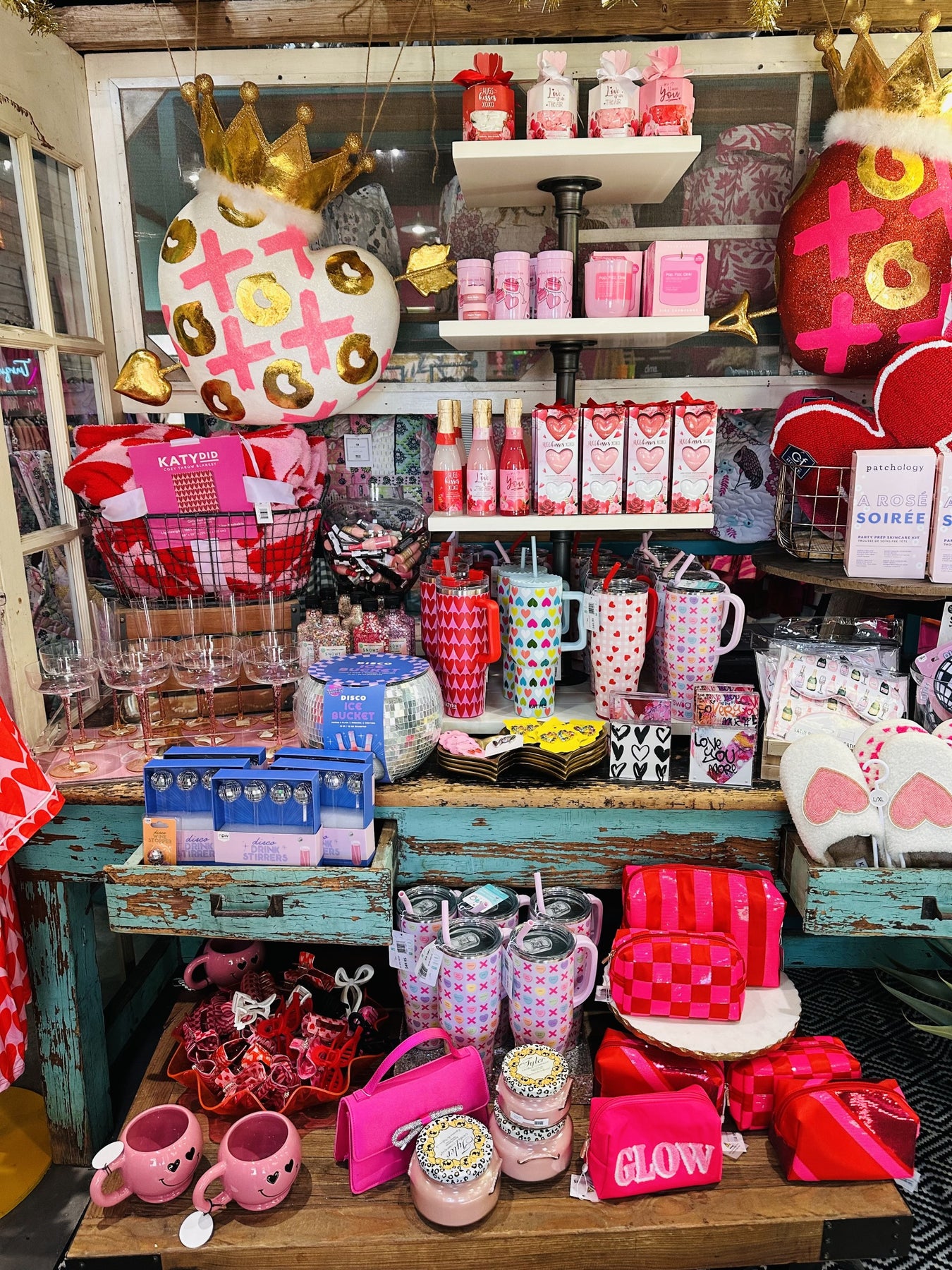 display table with valentine gift items, cups, slippers, bath products